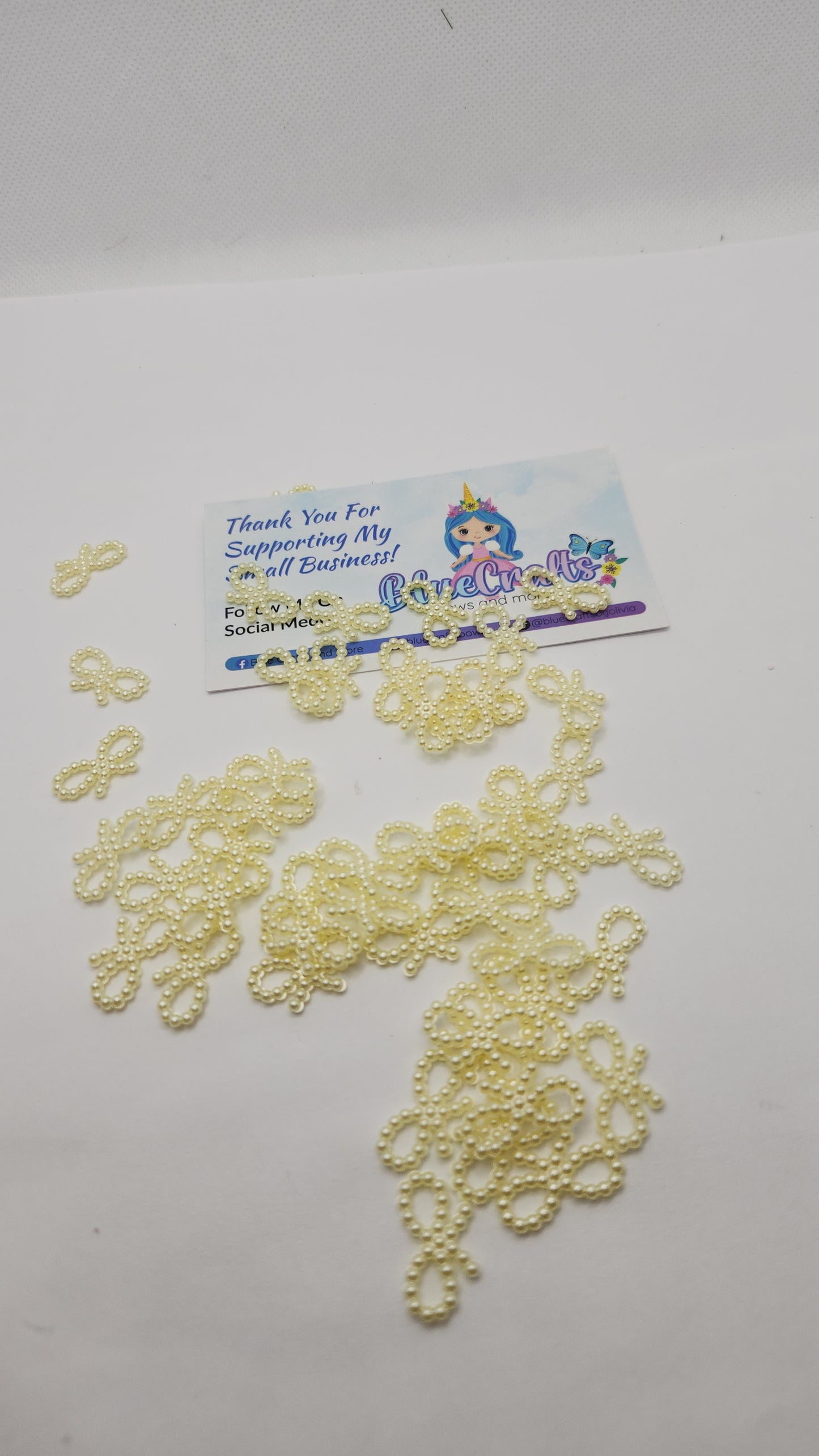 Mini pearls bows charms 50 count each set..