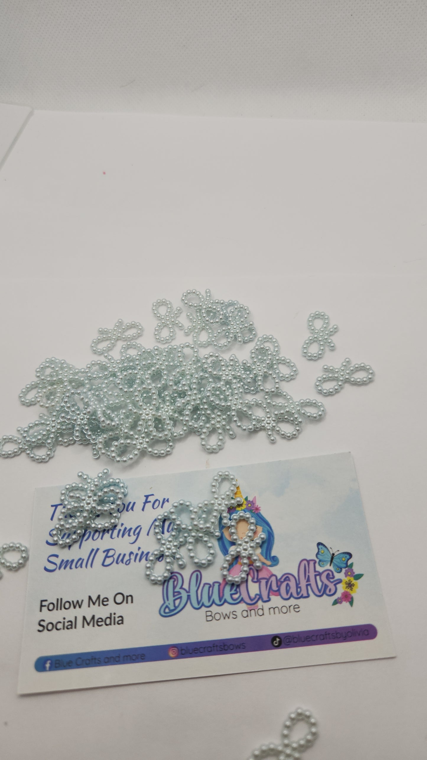 Mini pearls bows charms 50 count each set..